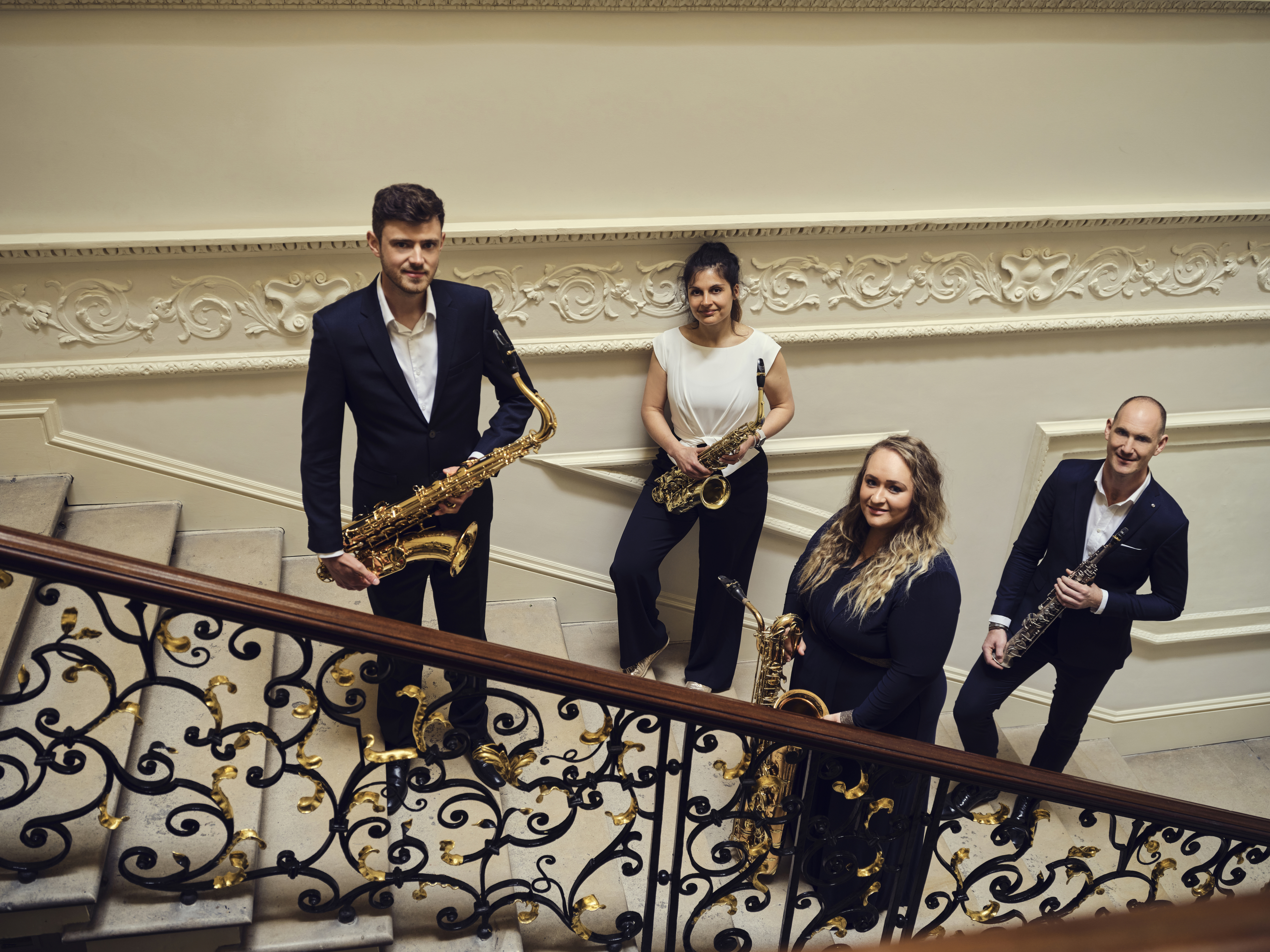 four musicians stood on a staircase